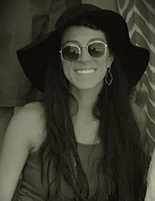 Victoria smiling, wearing hat and sunglasses